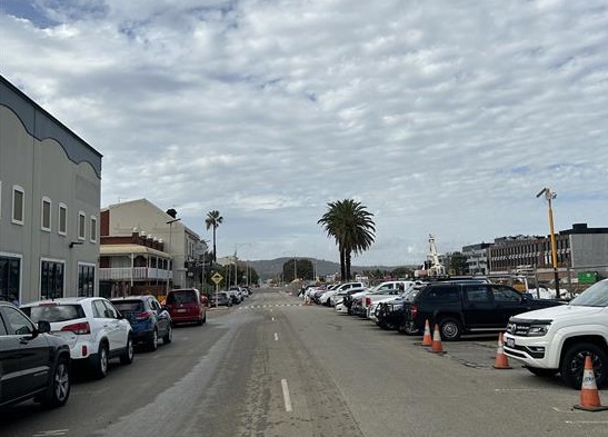 Cars parked either side of a road 